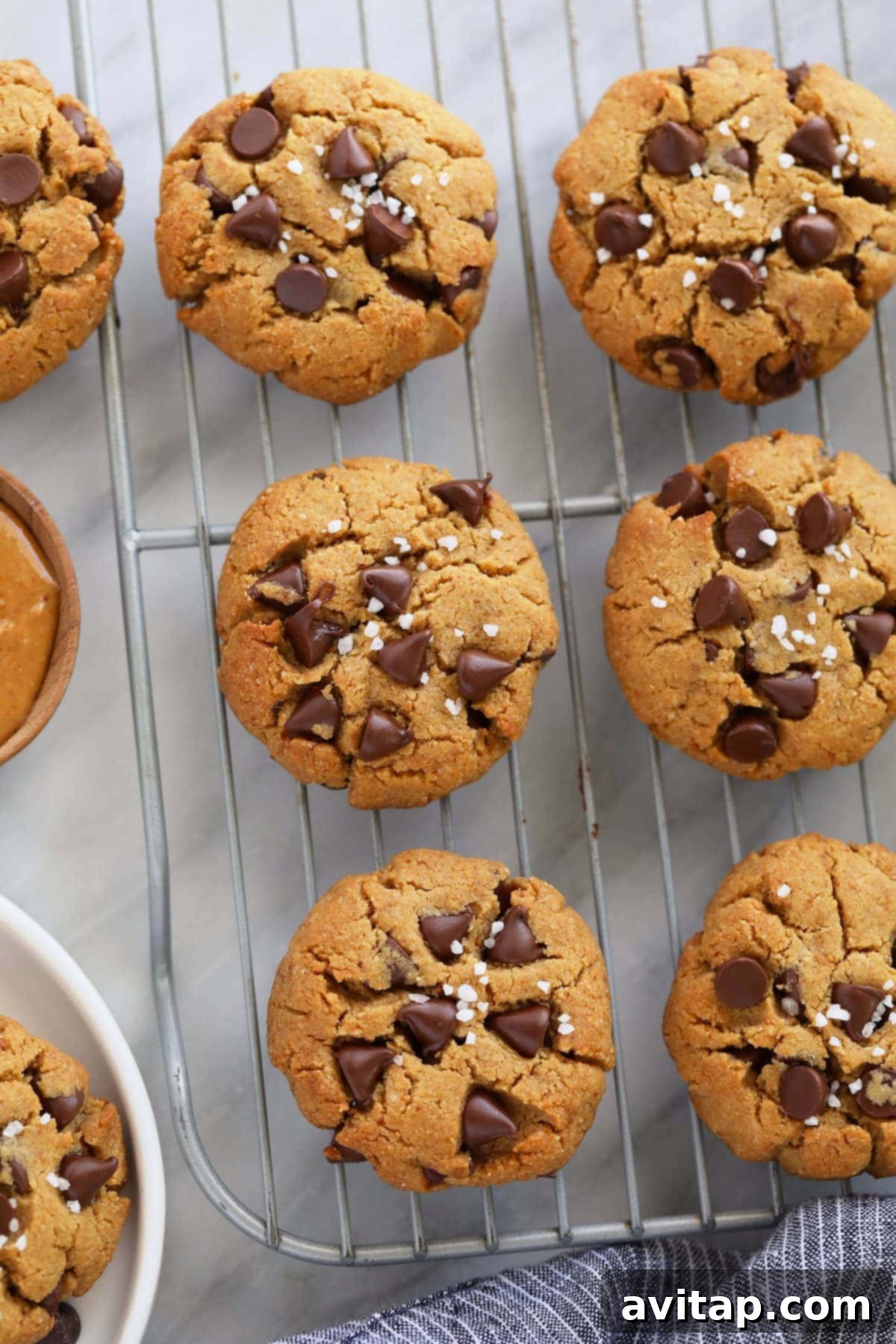 Freshly baked healthy peanut butter cookies cooling on a wire rack, ready to be enjoyed.