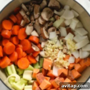A white bowl filled with a savory Sweet Potato Lentil Stew.
