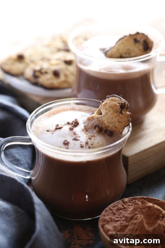 Close-up of a Spiked Hot Cocoa mug, showing creamy texture and potential garnishes