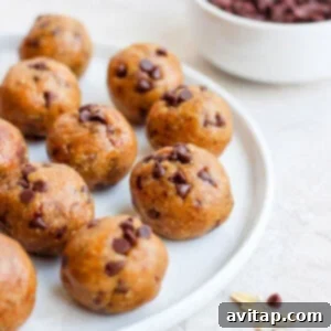 Delicious cookie dough energy bites, perfect for a healthy and quick snack. A visually appealing stack of golden-brown energy bites, resembling cookie dough, on a textured surface, ready to be enjoyed as a healthy snack.