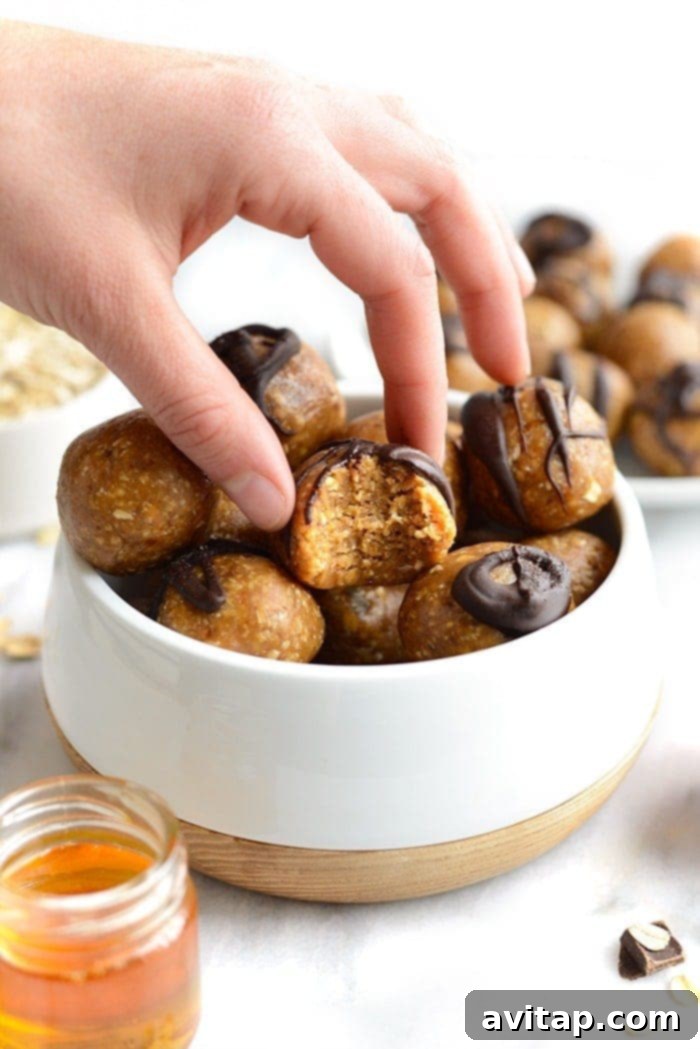 The ultimate peanut butter energy balls – quick, healthy, and incredibly delicious for any time. A stack of perfectly round peanut butter energy balls, showcasing their smooth texture and tempting appeal, ready for a healthy snack.