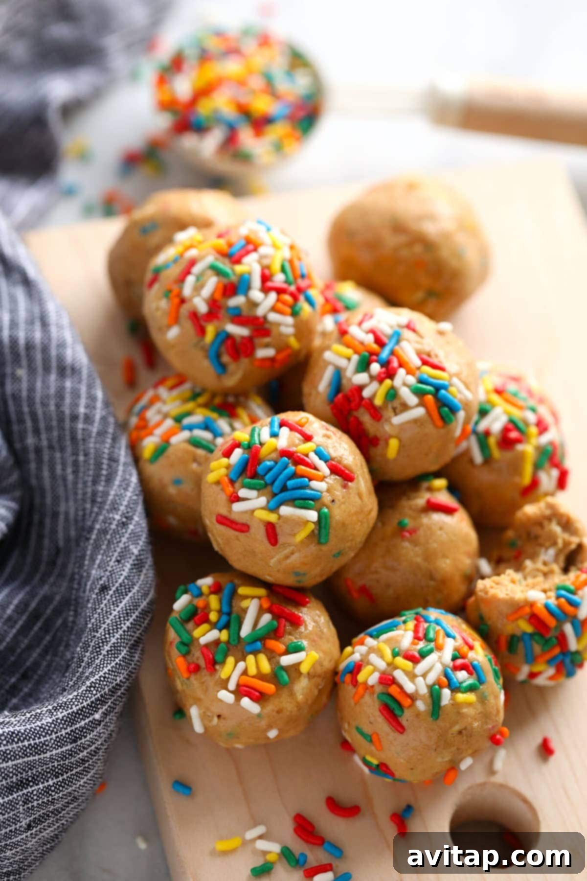 Flavorful cake batter protein balls, an easy no-processor snack that's fun and healthy. A colorful assortment of cake batter protein balls, elegantly arranged on a tiered serving tray, inviting a fun and healthy snack experience.