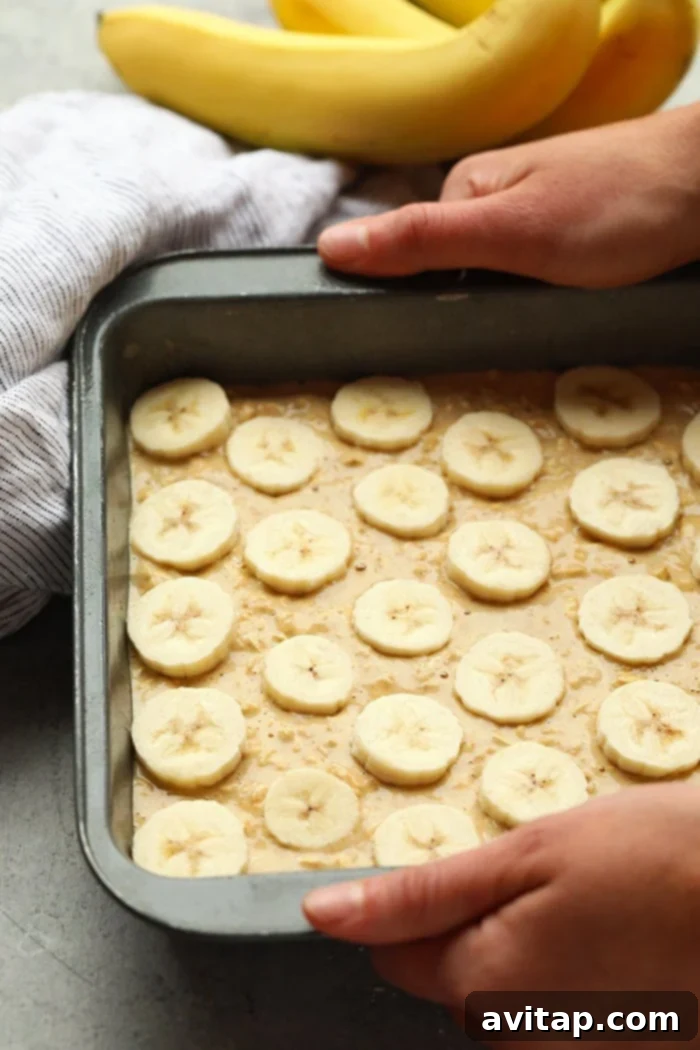 Baked oatmeal queens do we have a recipe for you! This Peanut Butter Banana Baked Oatmeal is perfectly sweetened with mashed banana and a little bit of maple syrup and gluten-free made with ground oat flour and rolled oats. Make this on the weekend for the family or during the week for a healthy breakfast meal prep recipe. baked oatmeal