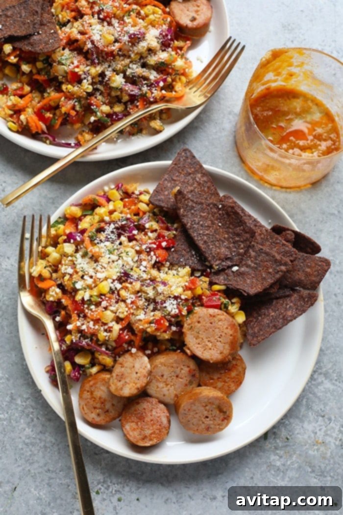 Serve this versatile Thai Chili Corn Salad as a delicious side dish with grilled sausage, crispy tortilla chips, or any of your cherished main courses. A guaranteed family favorite! Thai Chili Corn Salad served alongside grilled sausage and tortilla chips, perfect for a casual meal.