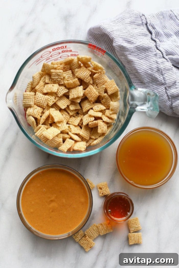 Separate bowls containing Chex cereal, creamy peanut butter, golden honey, and brown rice syrup, ready for mixing.