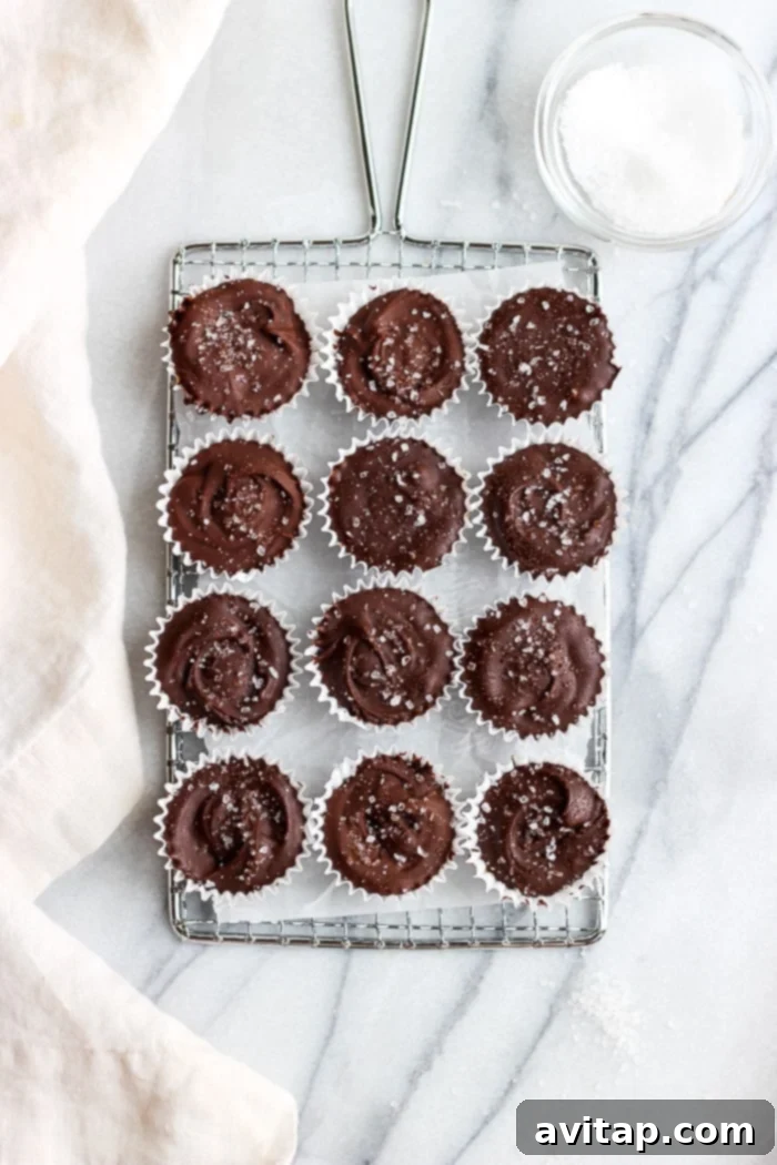 A batch of freshly made Pumpkin Peanut Butter Cups, garnished with sea salt