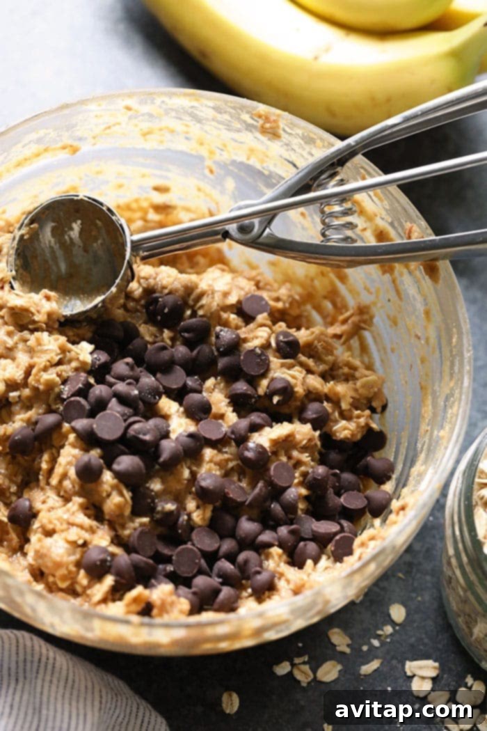 A close-up photo of the healthy vegan peanut butter banana cookie dough in a mixing bowl, showcasing its rich texture before baking.