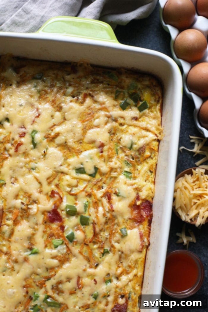 The perfectly baked Sweet Potato Hash Breakfast Casserole, generously sprinkled with golden melted cheese on top.