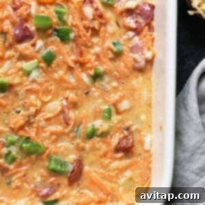 A healthy breakfast casserole with ham, cheese, and green onions before baking.