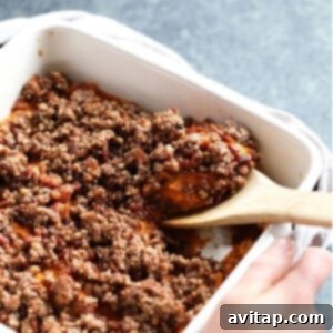A delicious healthy sweet potato casserole with a pecan streusel topping, golden brown and ready to be served from a festive dish.