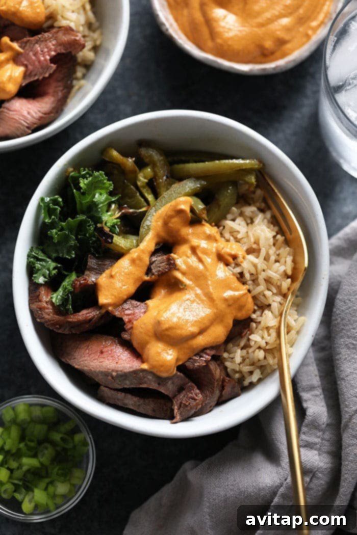 A close-up of a prepared Philly Cheese Steak meal prep bowl, showcasing the vibrant ingredients.