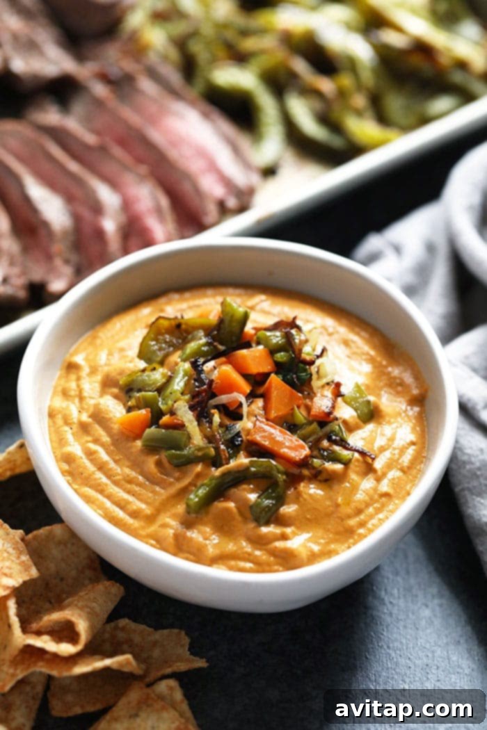 A bowl of rich, creamy vegan queso ready for dipping.