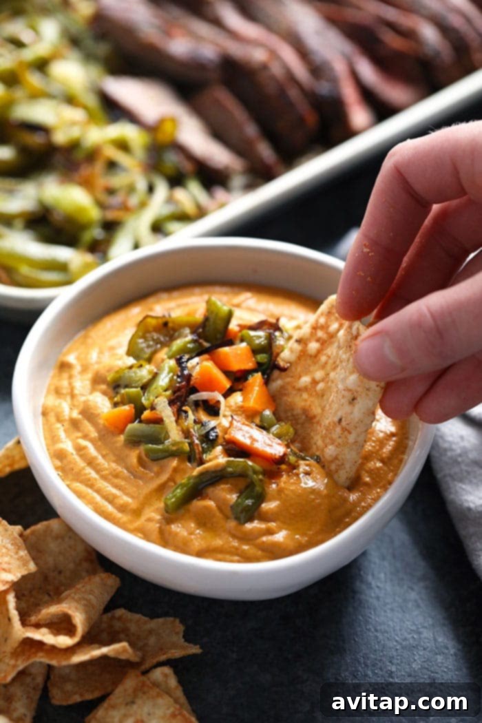 A beautifully presented bowl of vegan queso, garnished and ready to serve.