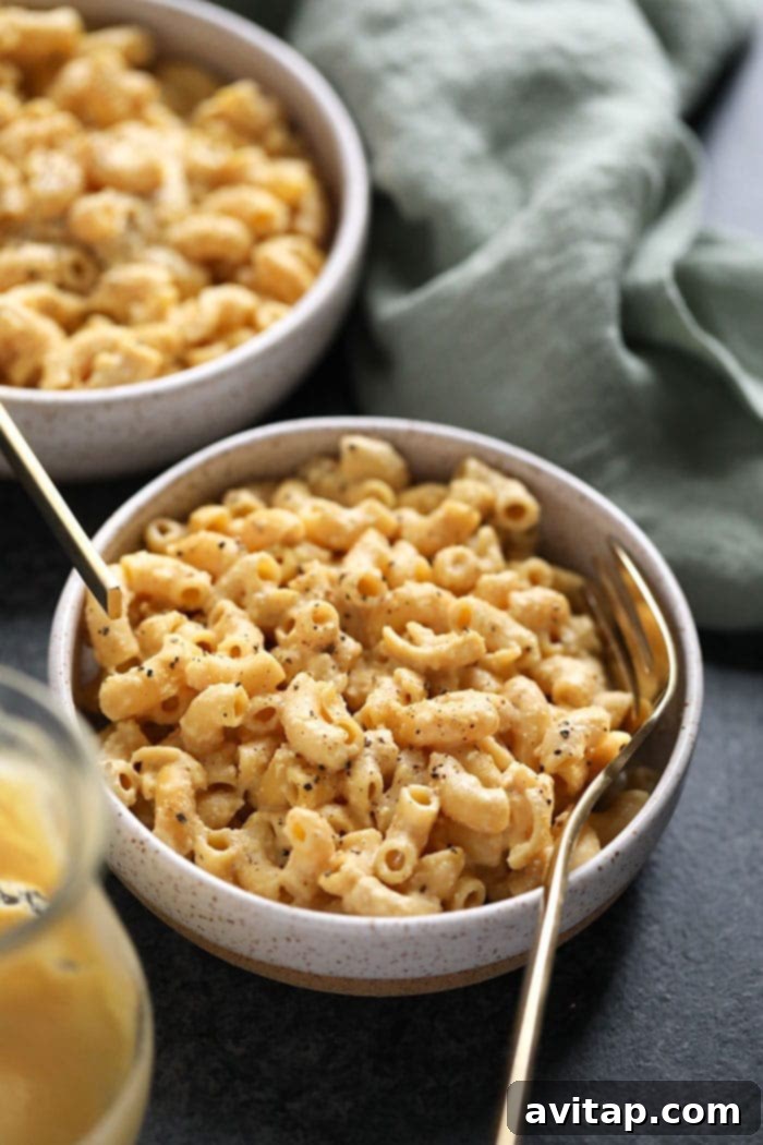 A beautifully presented bowl of creamy vegan mac and cheese, garnished for a perfect meal.