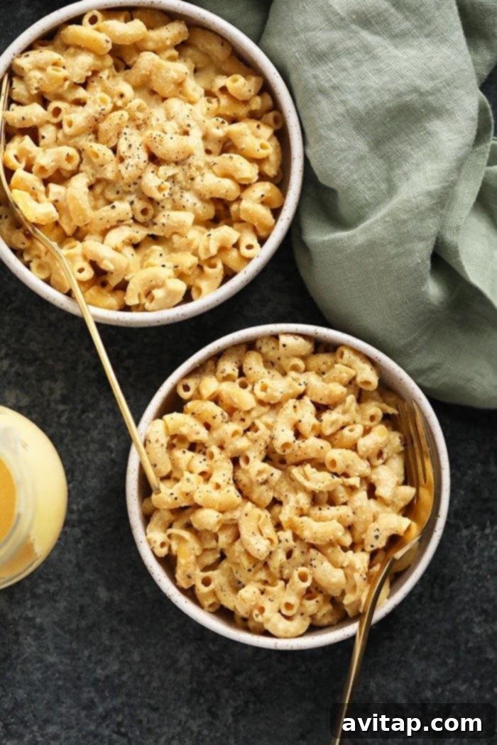 Multiple bowls of freshly made vegan mac and cheese, artfully arranged and ready to be enjoyed.