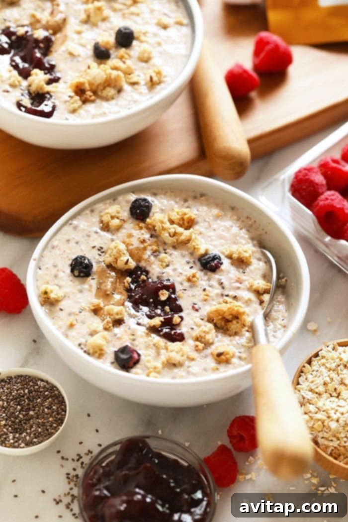 A close-up shot of creamy overnight steel cut oats in a glass jar, adorned with fresh berries and nuts.
