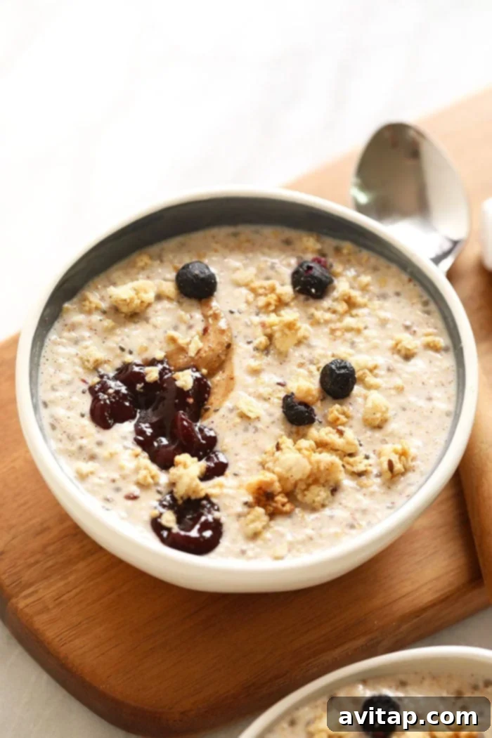 Overnight Steel Cut Oats in a rustic bowl with a spoon, highlighting the texture and readiness for consumption.