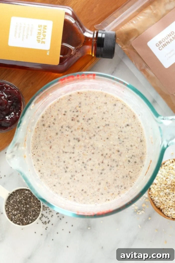 Overnight oats in a clear Pyrex container, showcasing the textures and readiness for a meal.