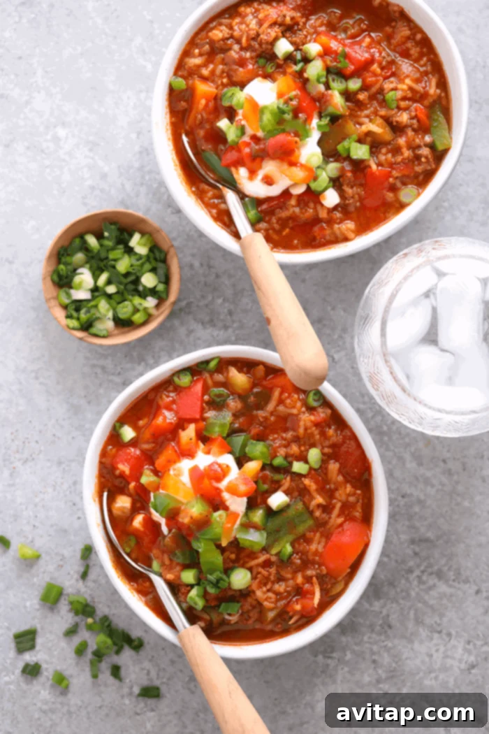 Instant Pot Stuffed Pepper Soup: A flavorful and easy one-pot meal perfect for meal prepping. Two bowls of Instant Pot Stuffed Pepper Soup, garnished with fresh herbs and a dollop of Greek yogurt.