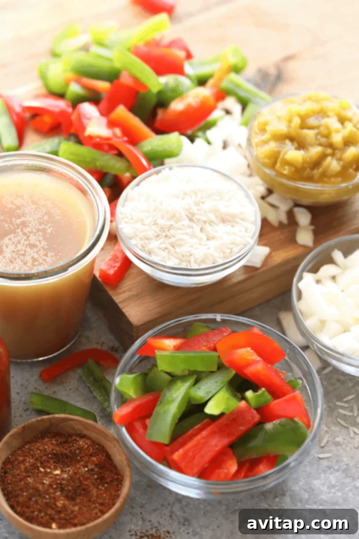 Gather your ingredients for this easy and flavorful Instant Pot Stuffed Pepper Soup. A perfect one-pot meal for any day! All the fresh ingredients for the Instant Pot Stuffed Pepper Soup, including bell peppers, ground beef, spices, and canned goods, laid out on a kitchen counter.