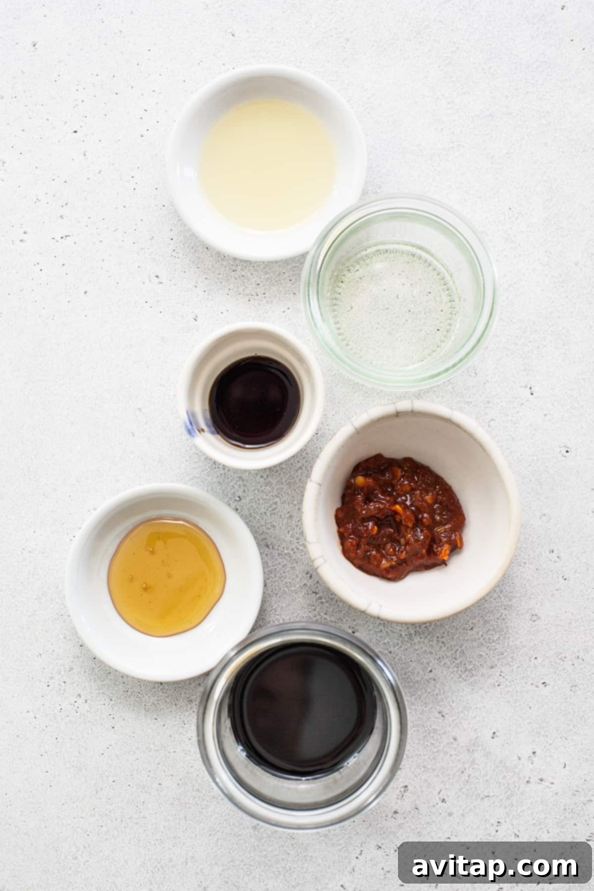 Individual ingredients for Instant Pot fried rice laid out in separate bowls.