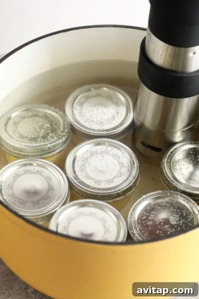 Jars of sous vide egg bites submerged in water in a pot.