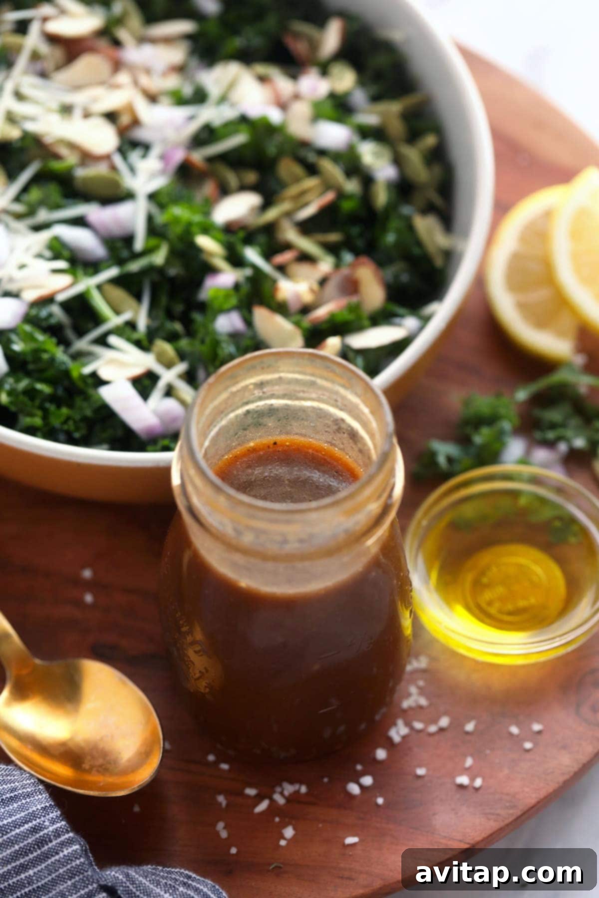 A beautifully composed salad with a small bowl of fresh homemade salad dressing, showcasing the freshness and appeal of DIY dressings.