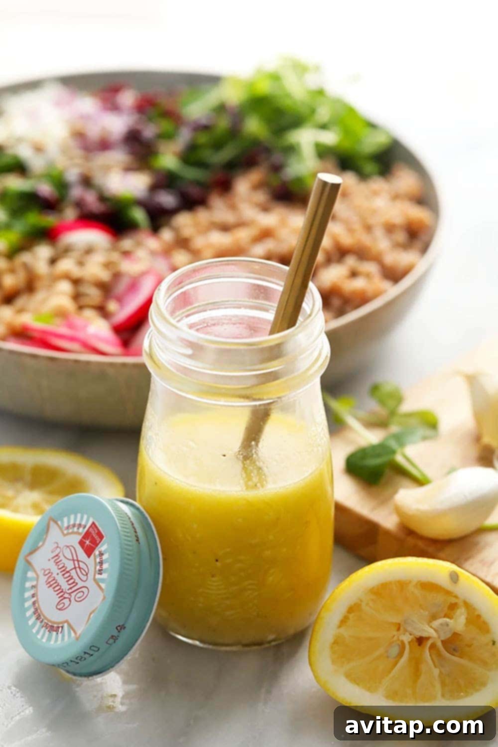 A jar of homemade lemon vinaigrette dressing, highlighting its fresh and bright ingredients.