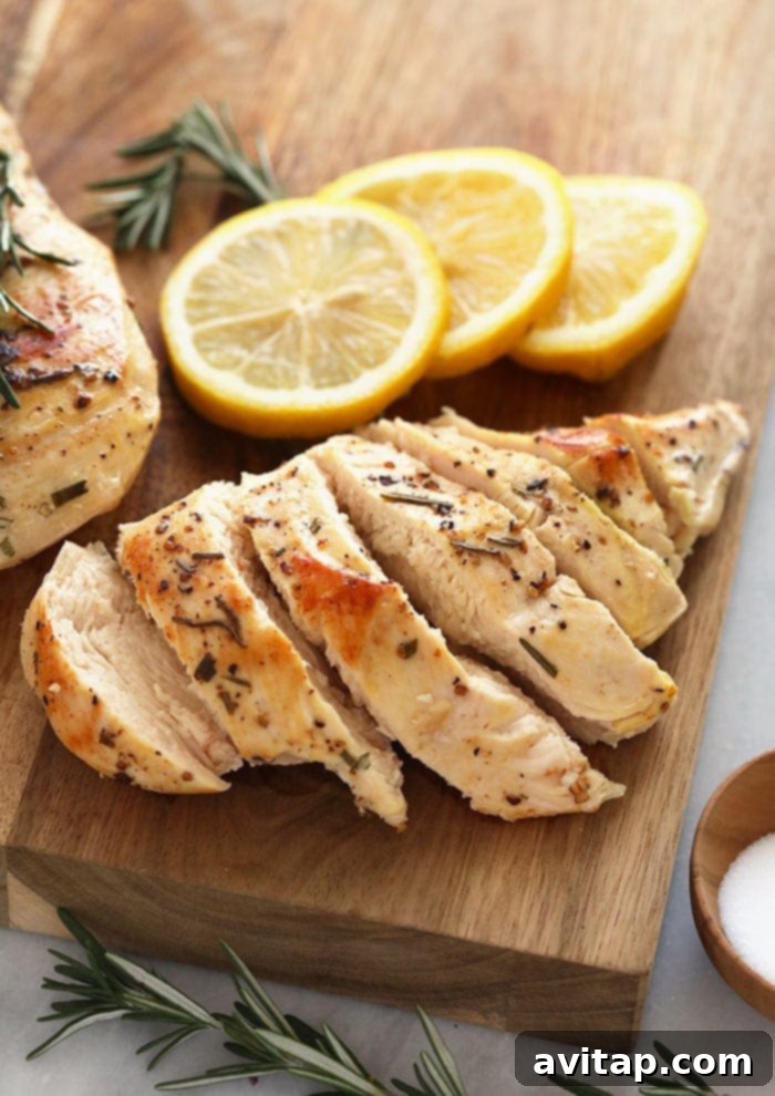 Perfectly cooked sous vide chicken breast on a cutting board, ready to be sliced.