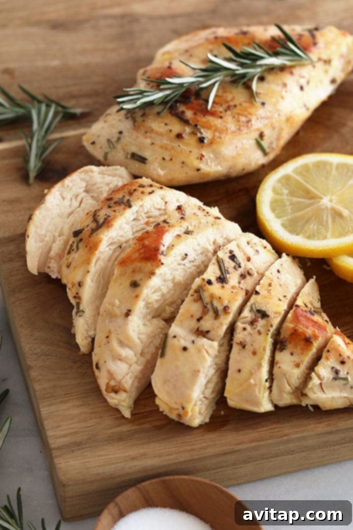 Perfectly sliced sous vide chicken breast on a cutting board, showcasing its juicy texture.
