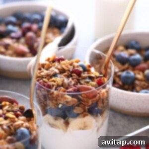 Effortless Granola Bliss 5 A bowl of granola packed with berries and raspberries, perfect for a healthy breakfast.