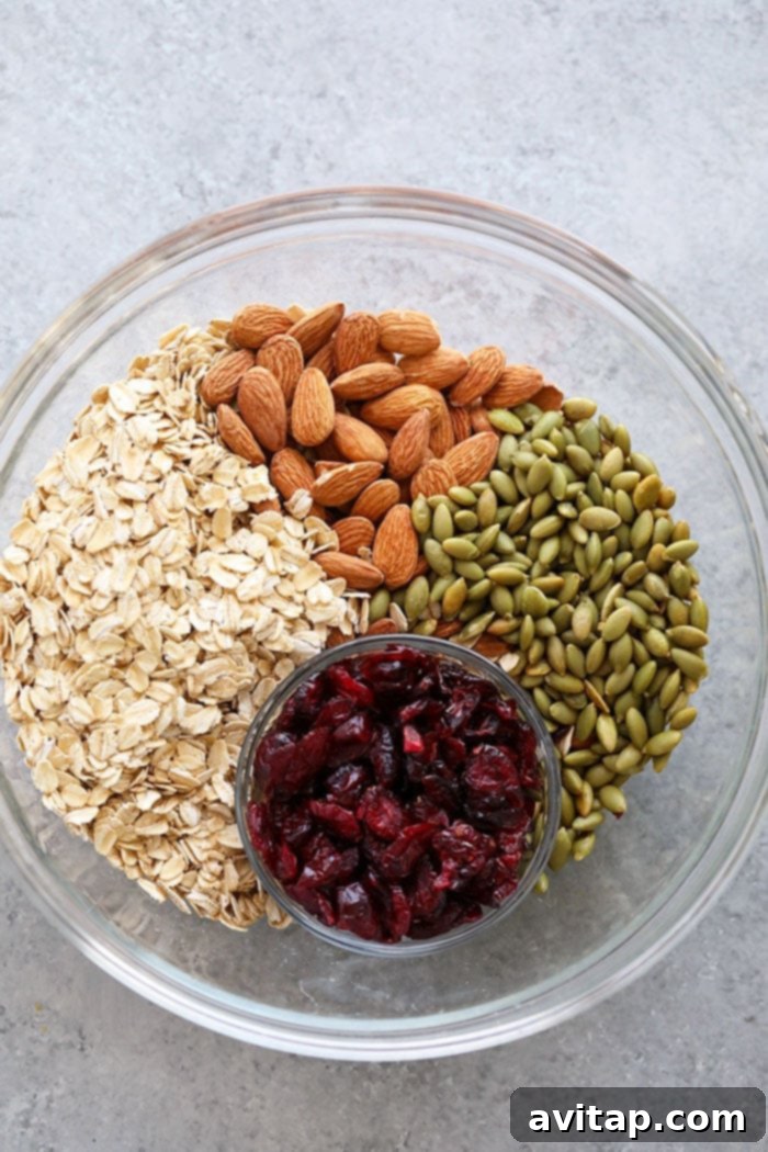 Granola Ingredients Ready for Mixing A bowl filled with the dry ingredients for healthy granola, including oats, almonds, and pepitas.