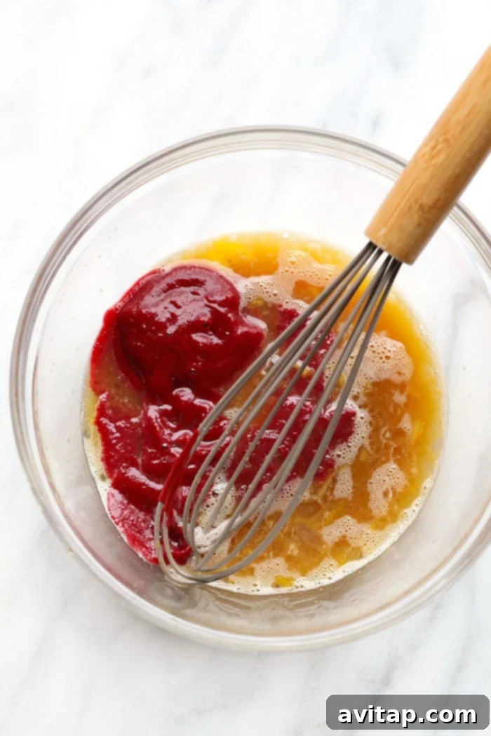 Wholesome ingredients ready for baking these delicious coconut flour and beet puree brownies. Bowl of ingredients for beet brownies, including beet puree, flours, and chocolate chips.