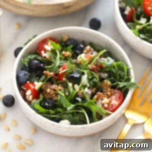 A bowl of healthy salad with fresh ingredients and vibrant colors.