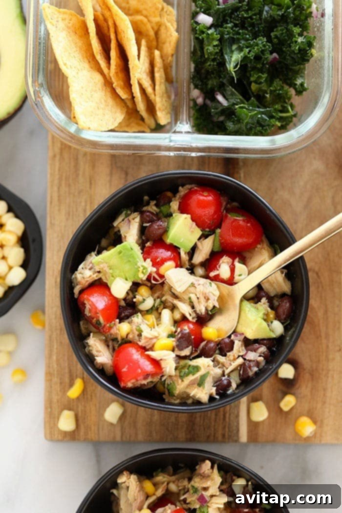 Fiesta Tuna Salad - a colorful, healthy tuna salad with black beans, corn, cherry tomatoes, and cilantro, served with a zesty lime vinaigrette.