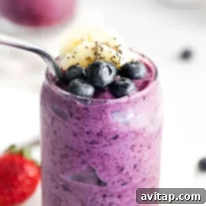 A triple berry smoothie with chia seeds and berries, ready to be served.