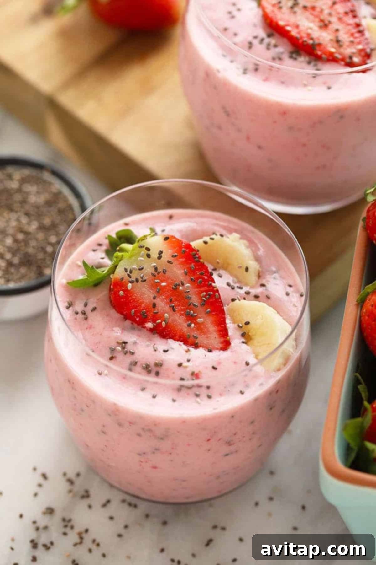fruit smoothie with strawberry on top.