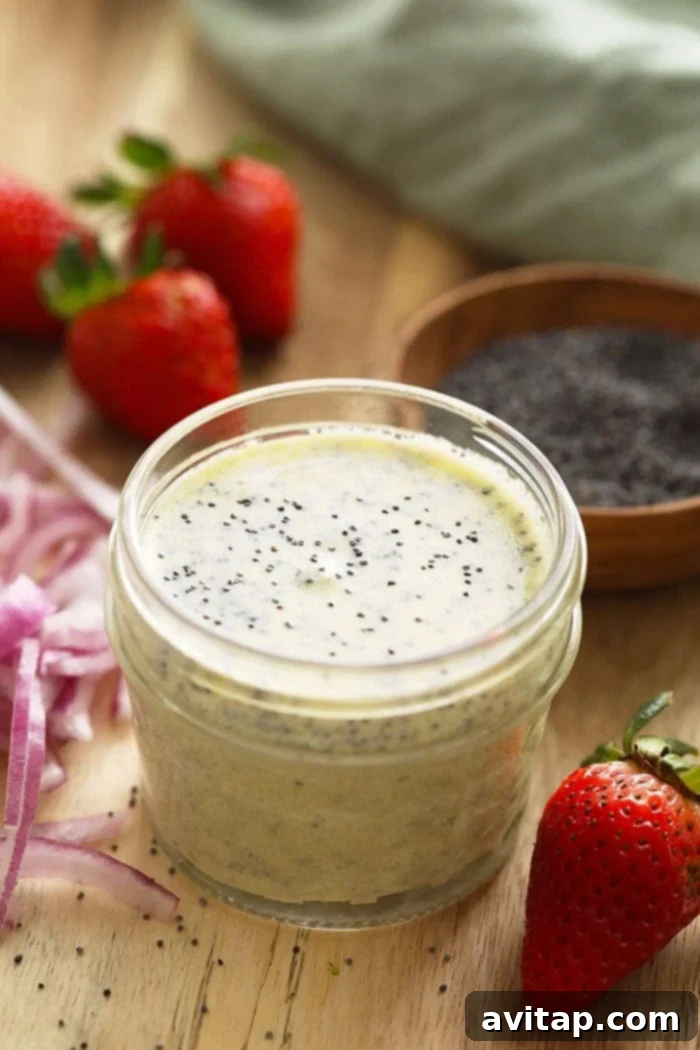 A jar of freshly made homemade poppy seed dressing, showcasing its creamy texture and visible poppy seeds.