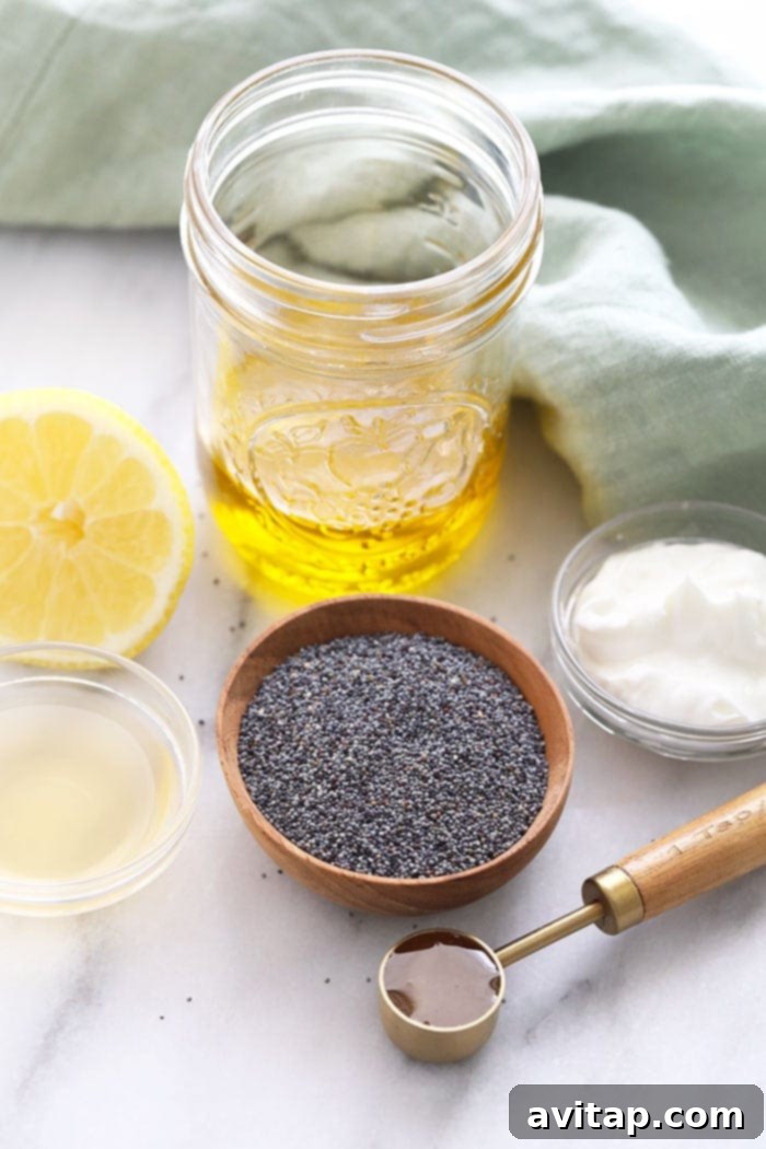 Small bowls containing the individual ingredients for homemade poppy seed dressing: olive oil, Greek yogurt, lemon juice, apple cider vinegar, honey, poppy seeds, and salt.