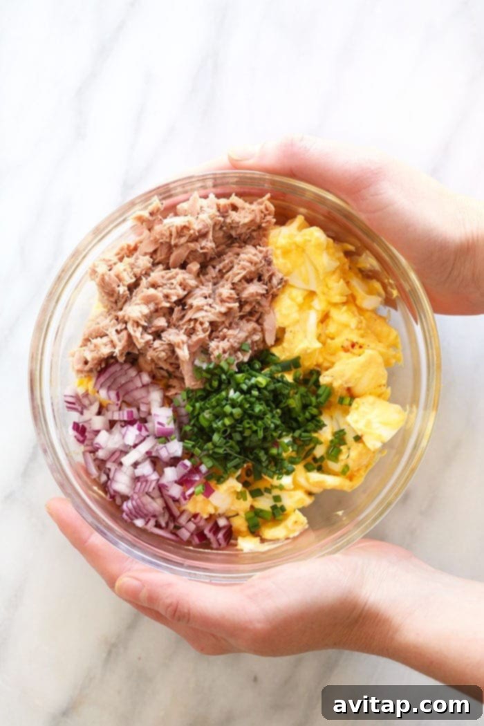 This Tuna Egg Salad blends the flavors you love from tuna salad with egg salad for a satisfying and protein-packed lunch! Filled with a short list of real ingredients, this tuna egg salad recipe can't be beat. Lunch is served! All the fresh ingredients for tuna egg salad arranged in separate bowls