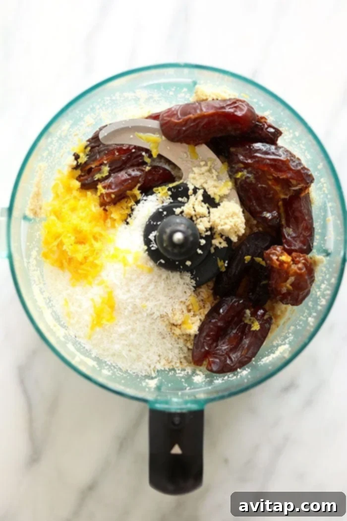 Mixing bowl with energy ball dough and chia seeds in a food processor
