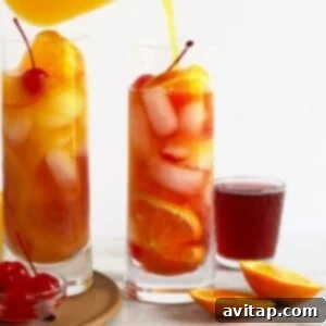 Classic Sex on the Beach cocktail, elegantly served in a tall glass with an orange slice and cherry garnish.
