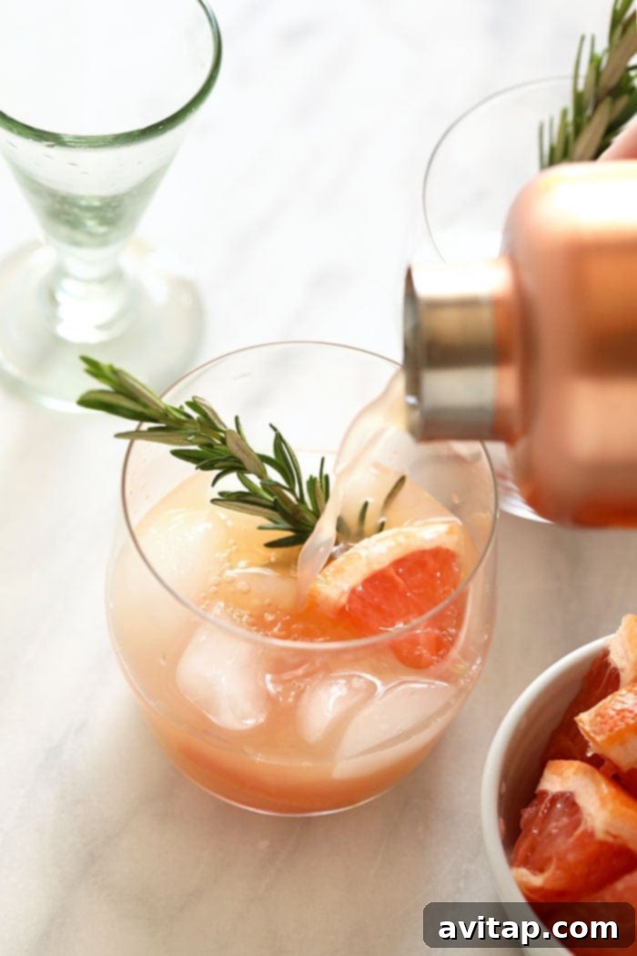 Pouring a greyhound cocktail into a glass