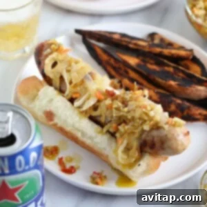 A delicious beer brat, cooked to perfection, in a bun.