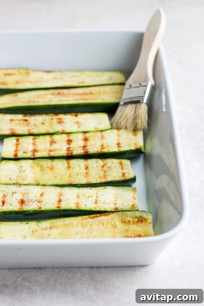 Perfectly grilled zucchini served in a elegant baking dish, showcasing golden-brown char marks.