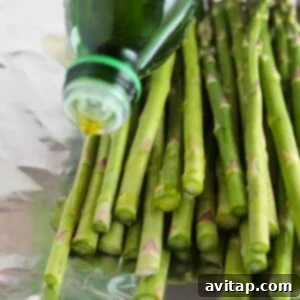 drizzling olive oil on asparagus.