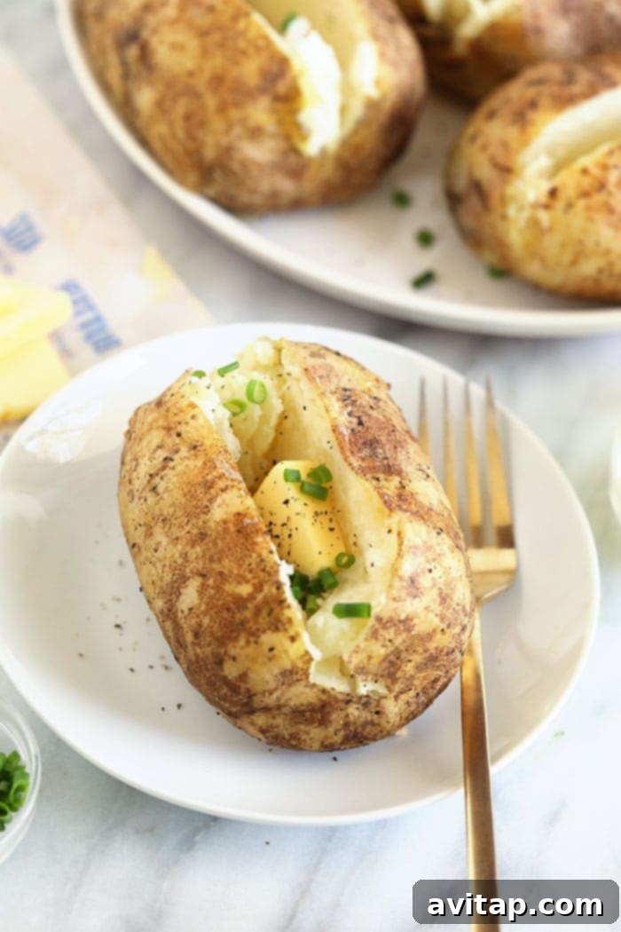 Baked Potatoes in Foil: Easy Idaho Potato Recipe with Butter Easy-to-make Idaho potatoes served in foil with a generous portion of melting butter and fresh chives.