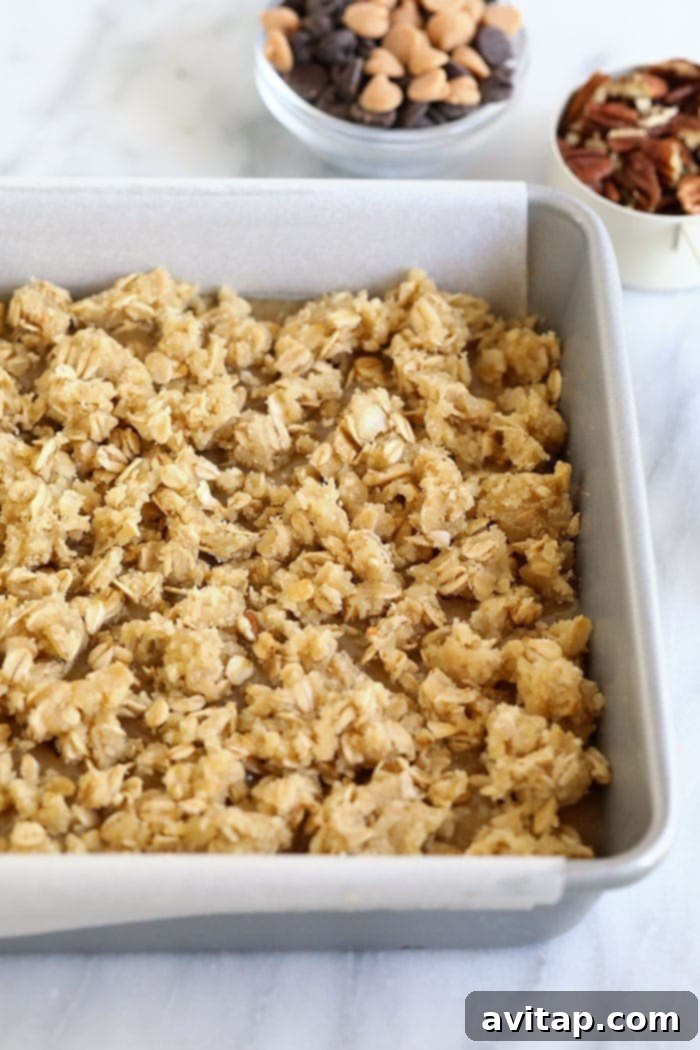 Close-up of baked Carmelita bars still in the pan, showing layers