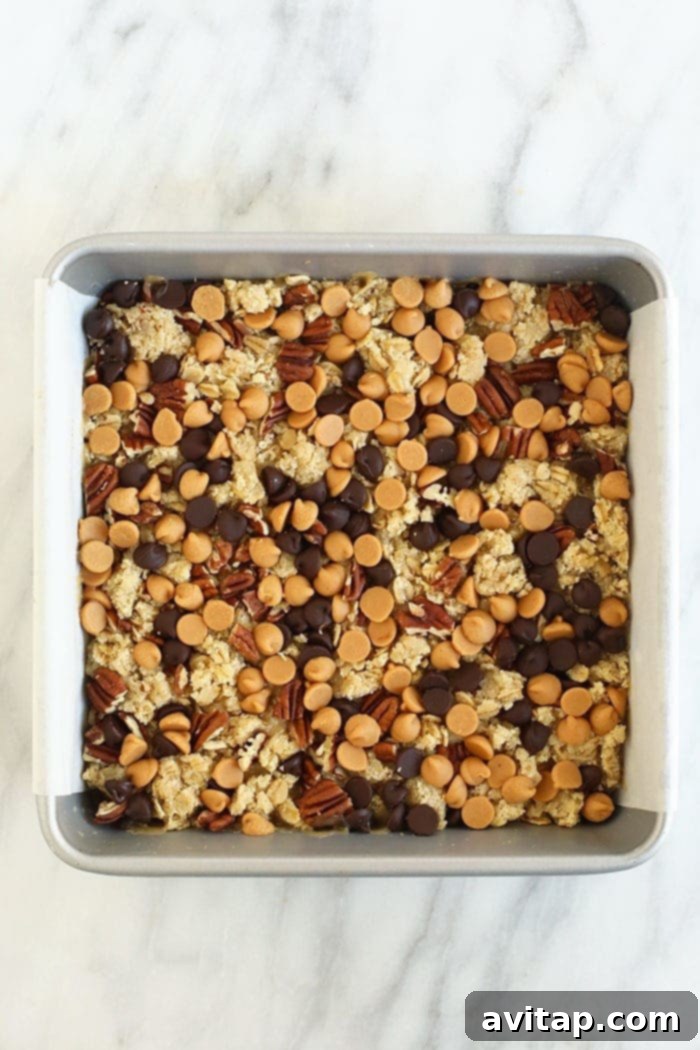 Baked Carmelita bar crust in a square pan, ready for the next layer