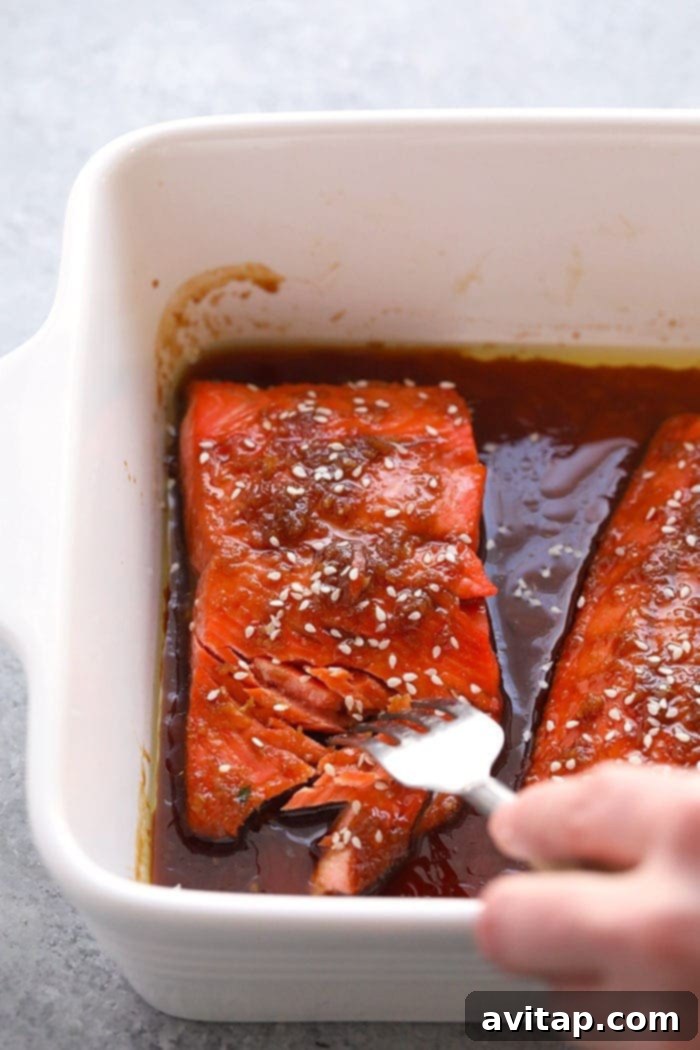 Beautifully baked maple ginger salmon fillets, showing a golden, caramelized glaze and perfectly cooked, flaky flesh.